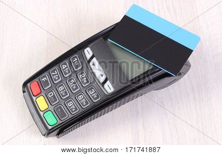 Payment Terminal With Contactless Credit Card On Wooden Background, Cashless Paying For Shopping Or