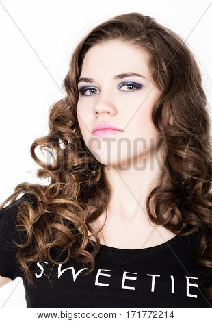 Young beautiful curly girl with professional make-up.