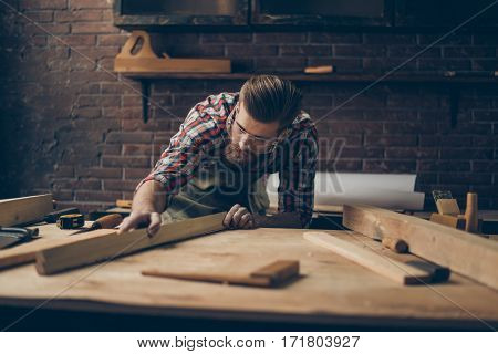 Bearded Handsome Cabinetmaker At The Tabletop With Tools.  Stylish Craftsman With Brutal Hairstyle A