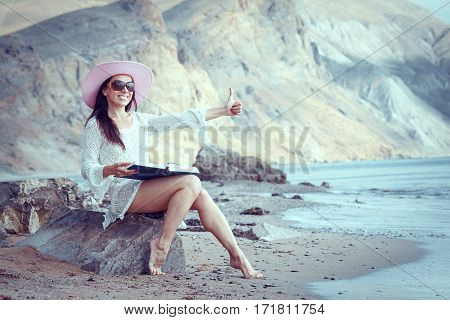 Happy woman enjoying beach relaxing joyful in summer by tropical blue water.