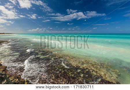 Tropical beach in Caribbean sea, Cayo Santa Maria island, Cuba. Exotic beach nature and clouds on horizon. Summer beach paradise.