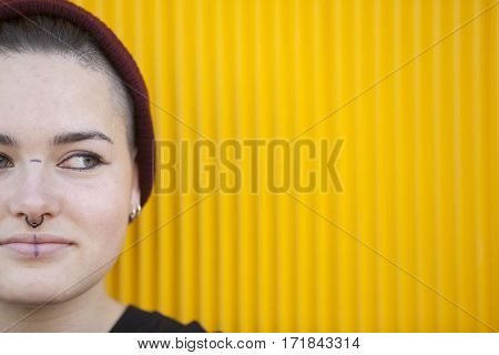 portrait of a teen lesbian woman isolated on a yellow wall