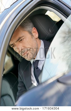 Private driver inside car waiting for client