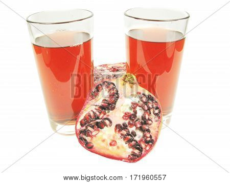 pomegranate juice drink in two glasses with cut fruit