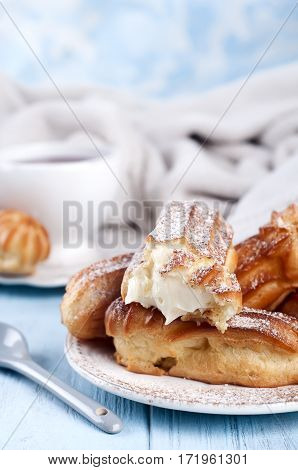 Tasty Eclairs On Wooden Table