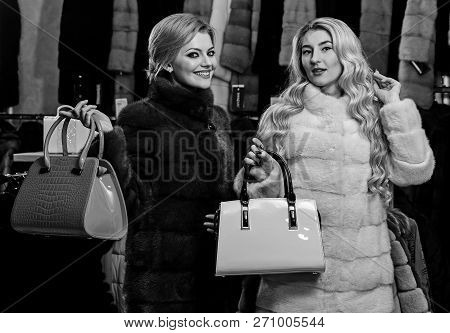 Women In Fur Coats With Bags In Fur Shop. Winter Clothing And Glamour Concept. Ladies With Makeup Sh