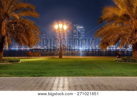 Beautiful View To Sharjah City Center Lights Skyline At Night, United Arab Emirates. Skyscrapers Are