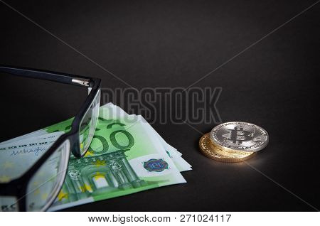Bitcoins Lie On A Dark Background With Euro, With Glasses, Close-up
