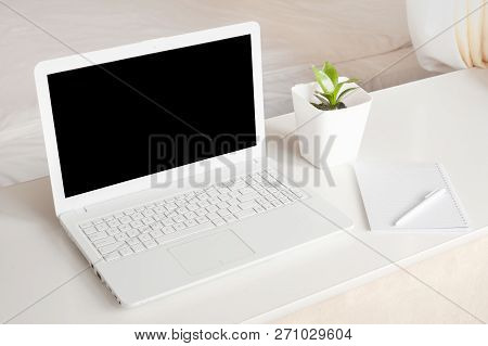 Completely White Modern Workspace With Laptop, Notepad, Plant And Pen. Minimal Pure Consept