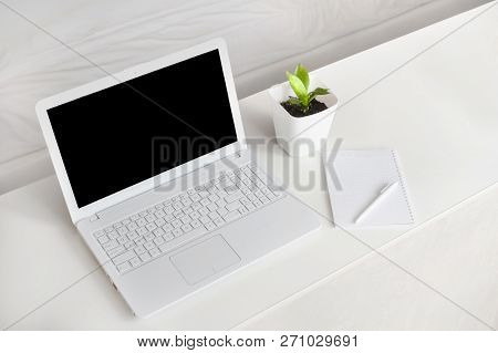 Completely White Modern Workspace With Laptop, Notepad, Plant And Pen. Minimal Pure Consept