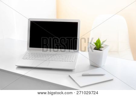 Completely White Modern Workspace With Laptop, Notepad, Plant And Pen. Minimal Pure Consept