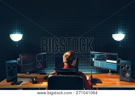 Video Editing. Professional Editor Adding Special Sound Effects. Back View Of Young Man Watching Gra
