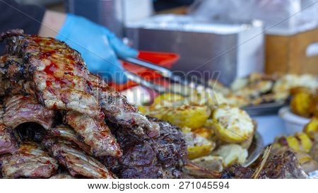 Grilled Pork Ribs On The Grill. Pork Ribs Cooking On The Grill, Very Tasty Hot Street Food