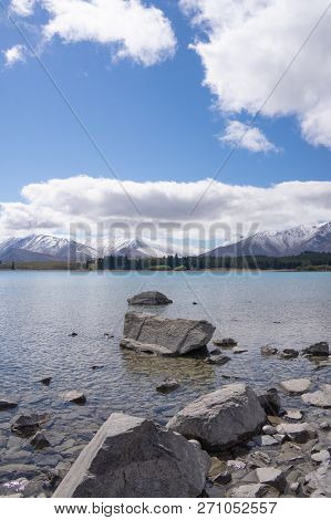 Ruataniwha Inlet Foreshore At Low Tide With Snow On Top Distant Mountains Under Dramaitc Clouds At C