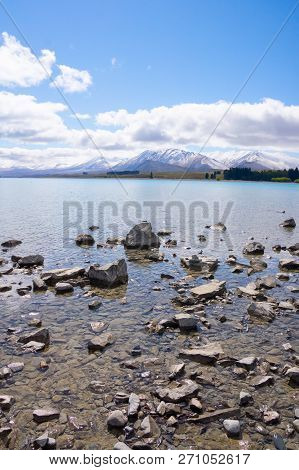 Ruataniwha Inlet Foreshore At Low Tide With Snow On Top Distant Mountains Under Dramaitc Clouds At C