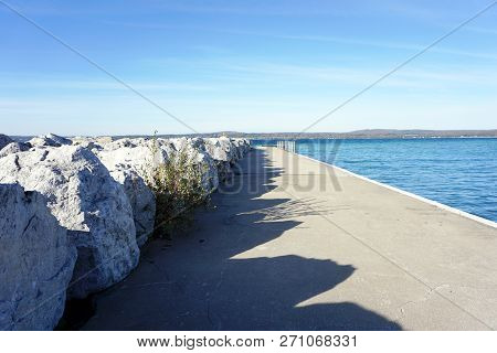 Large Boulders, Next To The Pier, Serve As A Breakwall To Protect The Bay View Swimming Beach From T