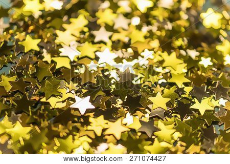 Golden Confetti Stars Scattered On The Surface.