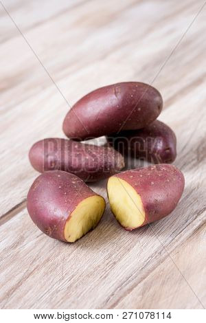closeup of some raw baby red potatoes on a rustic wooden table