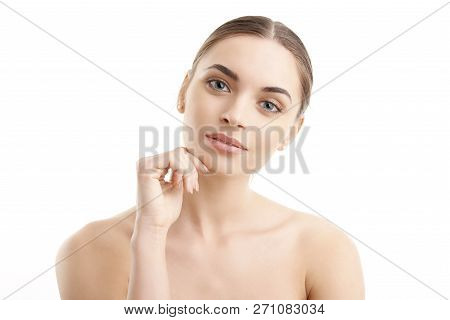 Gorgerous Young Woman With Hand On Chin Looking At Camera. Isolated On White Background.