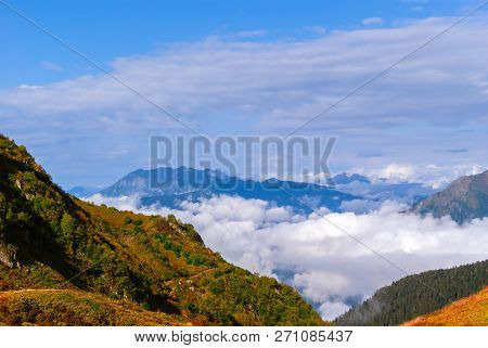 Landscape - View From The Mountain Top On A Sunny Day To The Valley Hidden By Low Clouds