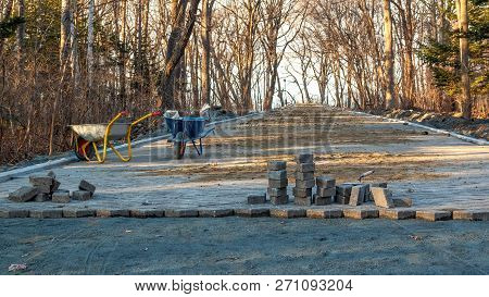 Construction Site And Paving On A Walking Path In A Public Park. Scene Of Preparatory Work With Cart