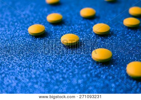 Small Yellow Orange Beautiful Medical Pharmaceptic Round Pills, Vitamins, Drugs, Antibiotics On A Bl