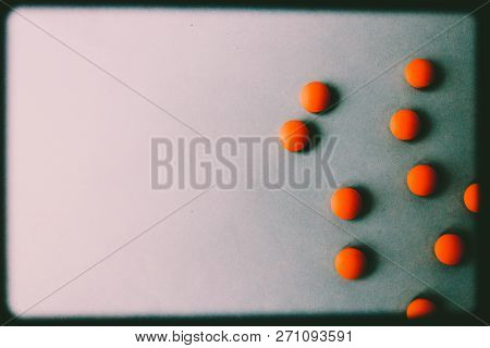 Small Yellow Orange Beautiful Medical Pharmaceptic Round Pills, Vitamins, Drugs, Antibiotics On A Bl