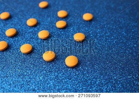 Small Yellow Orange Beautiful Medical Pharmaceptic Round Pills, Vitamins, Drugs, Antibiotics On A Bl