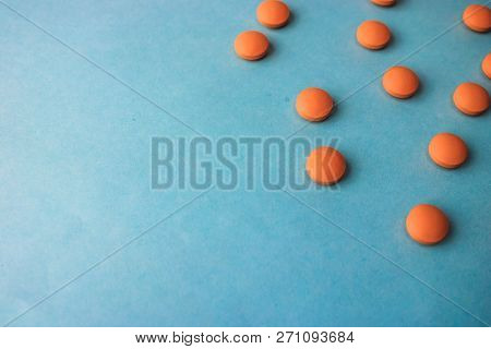 Small Yellow Orange Beautiful Medical Pharmaceptic Round Pills, Vitamins, Drugs, Antibiotics On A Bl