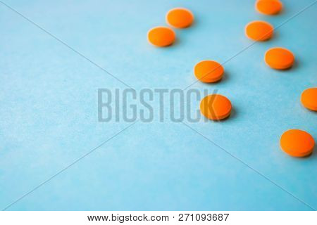 Small Yellow Orange Beautiful Medical Pharmaceptic Round Pills, Vitamins, Drugs, Antibiotics On A Bl