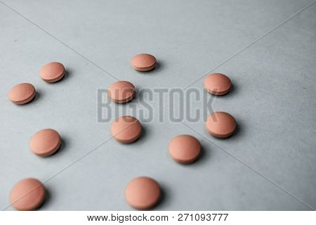 Small Yellow Orange Beautiful Medical Pharmaceptic Round Pills, Vitamins, Drugs, Antibiotics On A Bl