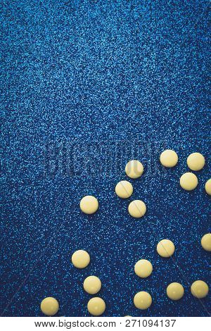 Small Yellow Orange Beautiful Medical Pharmaceptic Round Pills, Vitamins, Drugs, Antibiotics On A Bl