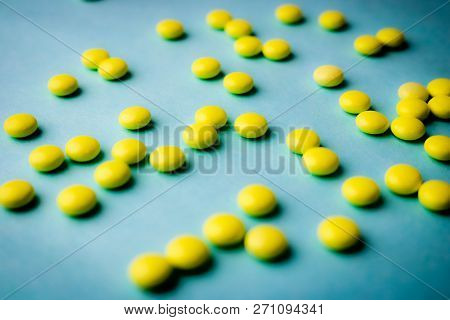 Small Yellow Orange Beautiful Medical Pharmaceptic Round Pills, Vitamins, Drugs, Antibiotics On A Bl