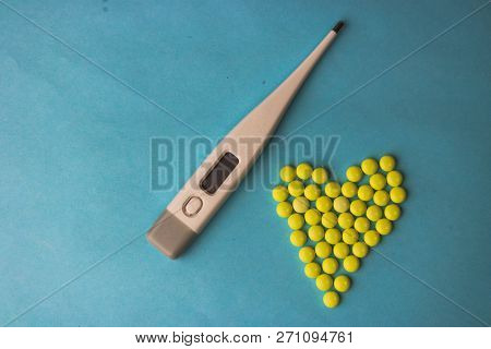 Small Medical Pharmaceptic Round Pills, Vitamins, Drugs In The Form Of A Heart And Electronic Thermo