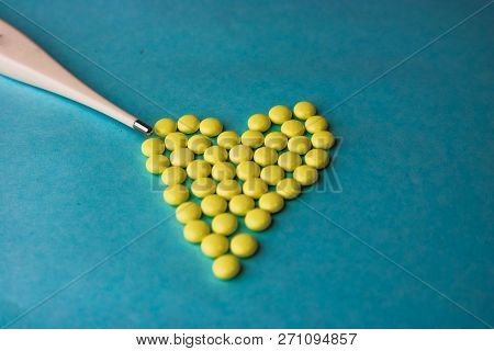 Small Medical Pharmaceptic Round Pills, Vitamins, Drugs In The Form Of A Heart And Electronic Thermo