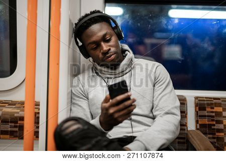 Bored man texting while on the train