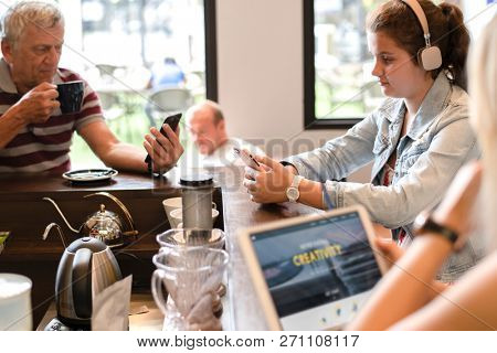 Customers at a cafe all preoccupied by social media
