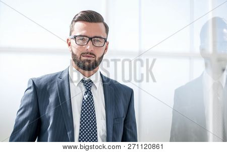 confident businessman on background of office windo