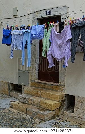 A typical story in the old part of the city cloths . Beco Cruzes 8 Street, Lisbon, Portugal, November 02, 2018.