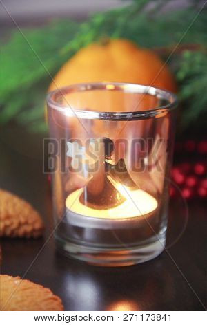 Christmas Cookies With Sugar, Mandarina And A Candle In A Candlestick On The Background Of A Green C