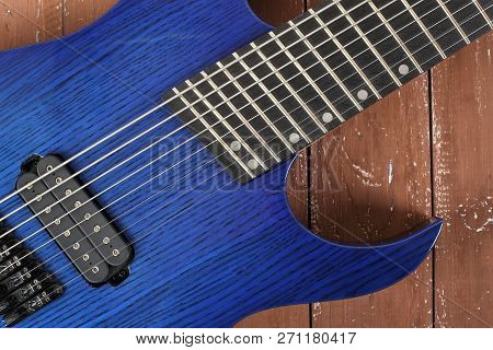 Musical Instrument - Fragment 8-string Blue Electric Guitar Solid-body On A Wood Background
