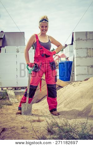 Person Using Shovel On Construction Site