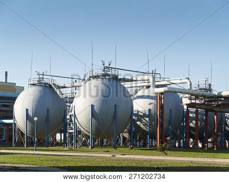 Industrial Landscape With View Of Several Ball Gasholders With Lightning Protection And Safety Valve