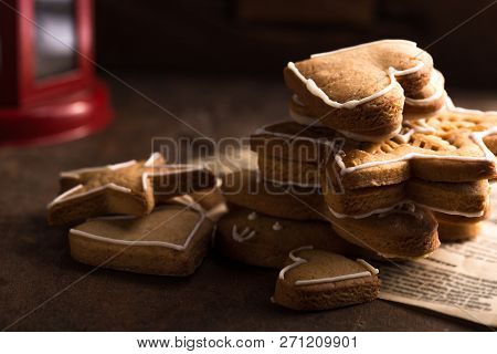 Christmas Holiday Background With Gingerbread Cookies, Candy Cane And Evergreens Border Over Wooden 