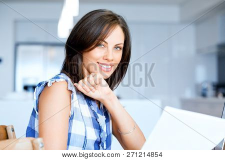 Woman with papers in their living room