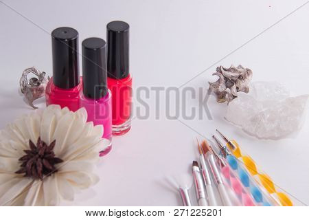 Three Jars Of Lacquer Siyat On A White Background, Next To Them Are Tassels For Manicure And A Flowe