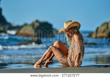 young woman relaxing on the beach in summer day