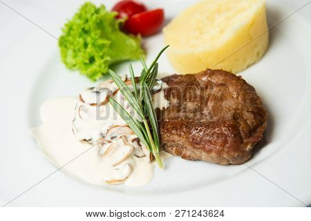 Juicy Fresh Roasted Steak With Champignons And Mashed Potatoes. Decorated With Salad, Cherry Tomatoe