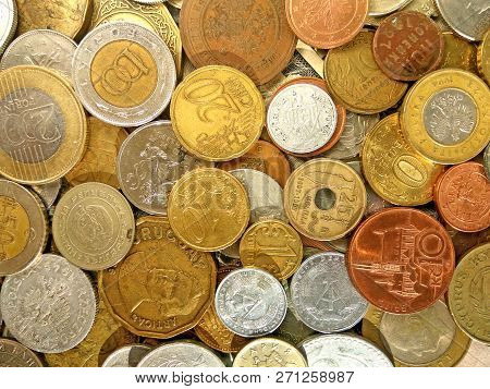 Close up top view image of large amount of old money coins of different countries and times on dolla