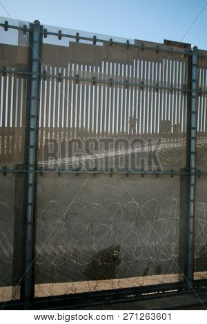 San Ysidro, California - 11/26/2018: Border fence between the USA and Mexico including New Construction adding an additional layer of fencing and razor wire or barbed wire to secure the border.